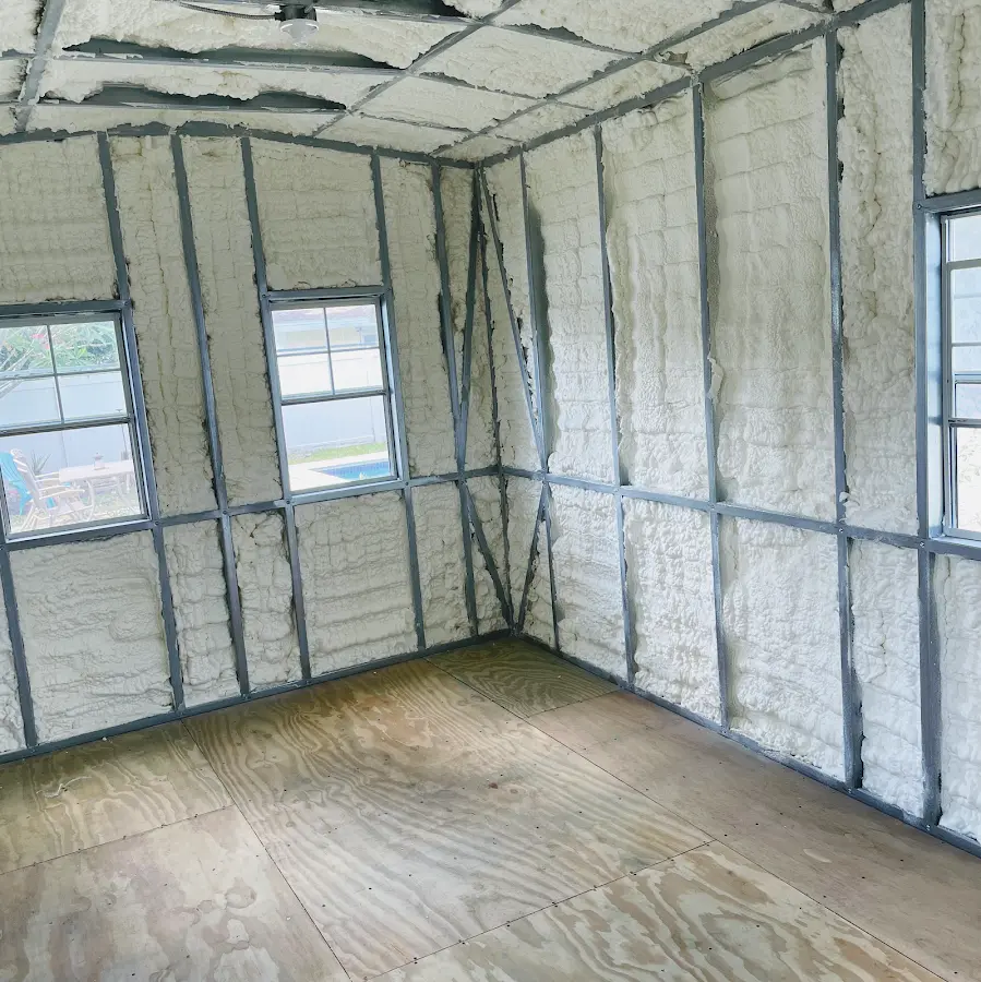 Closed-cell spray foam insulation applied to wall cavities in a residential project in Whitney